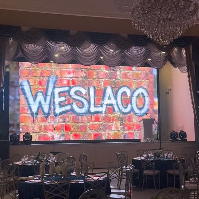 Weslaco LED backdrop over banquet tables at a corporate event