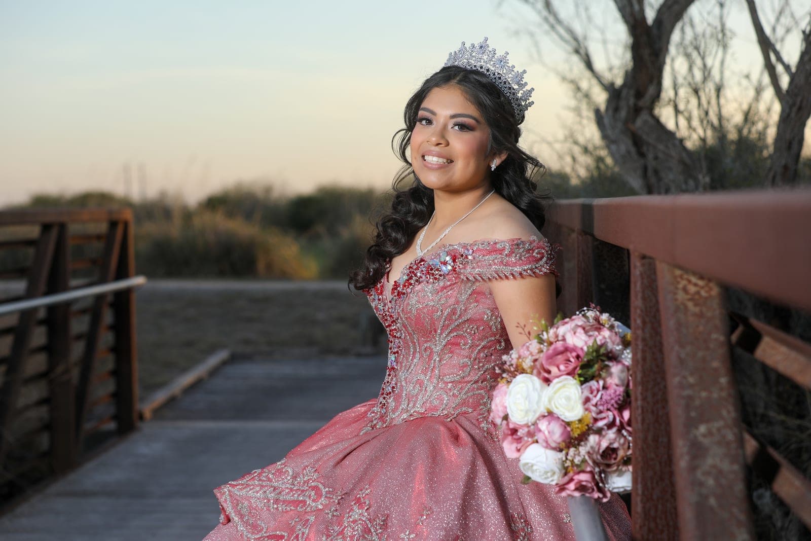 Quinceañera portrait on a wooden bridge