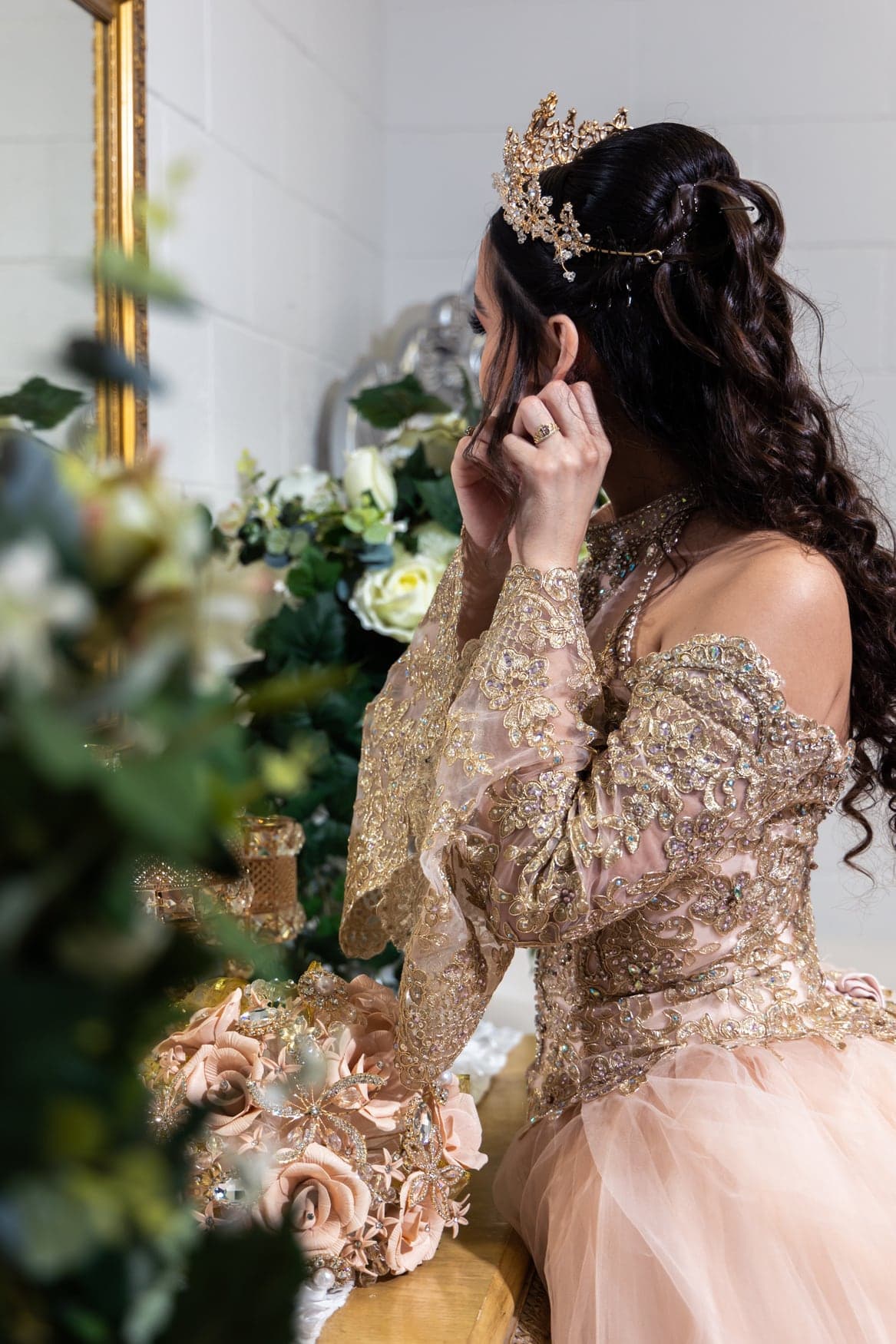 Quinceañera in a gold sequined ball gown