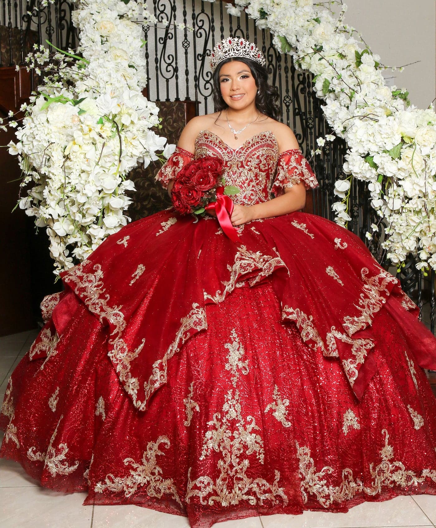 Quinceañera in a red gown with white florals and roses