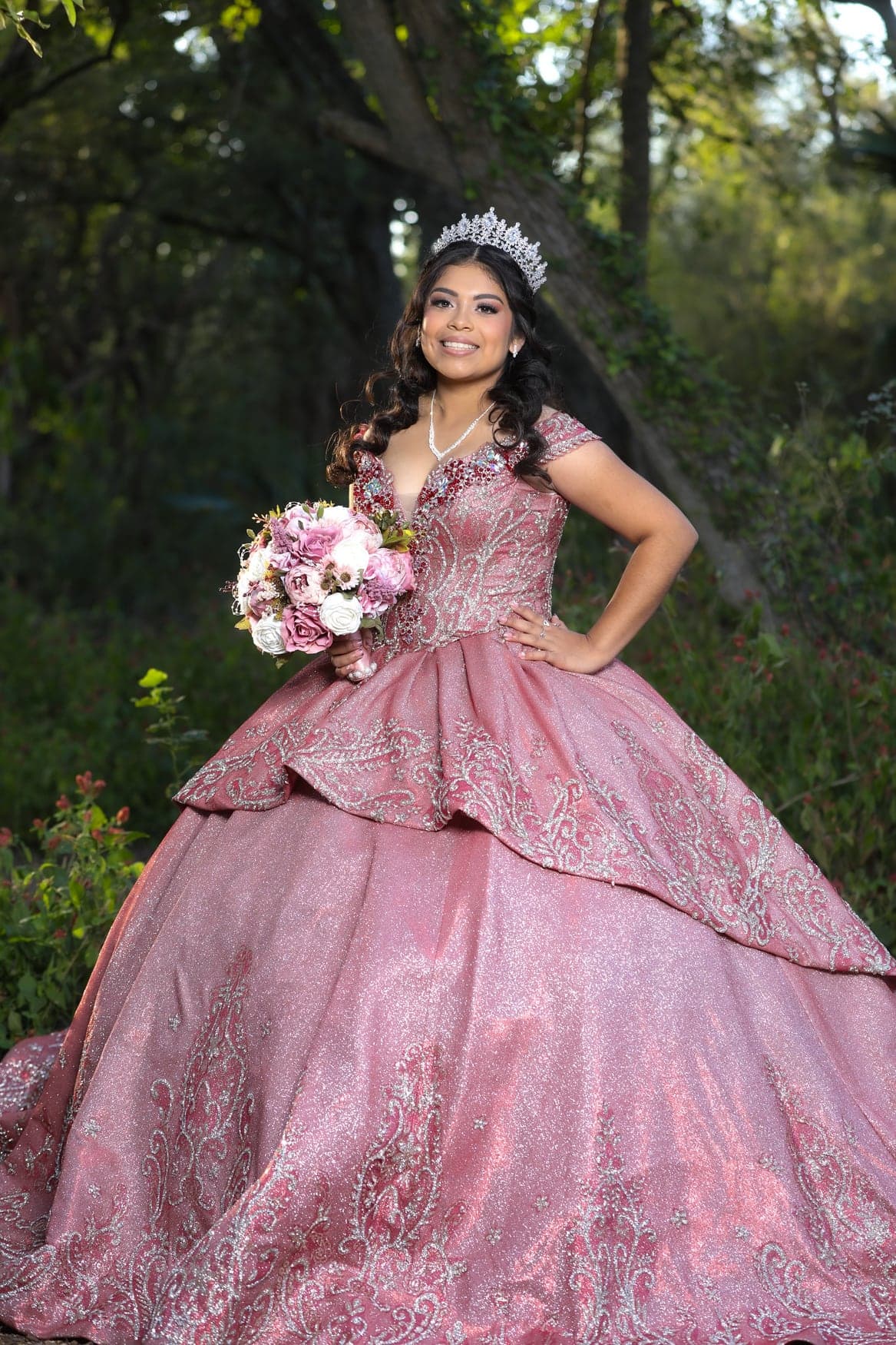 Quinceañera in a rose ball gown with her bouquet