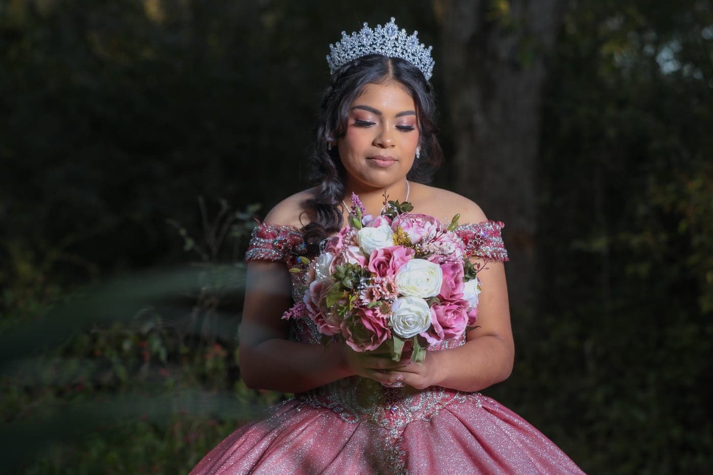 Quinceañera in a mauve gown with a tiara and bouquet