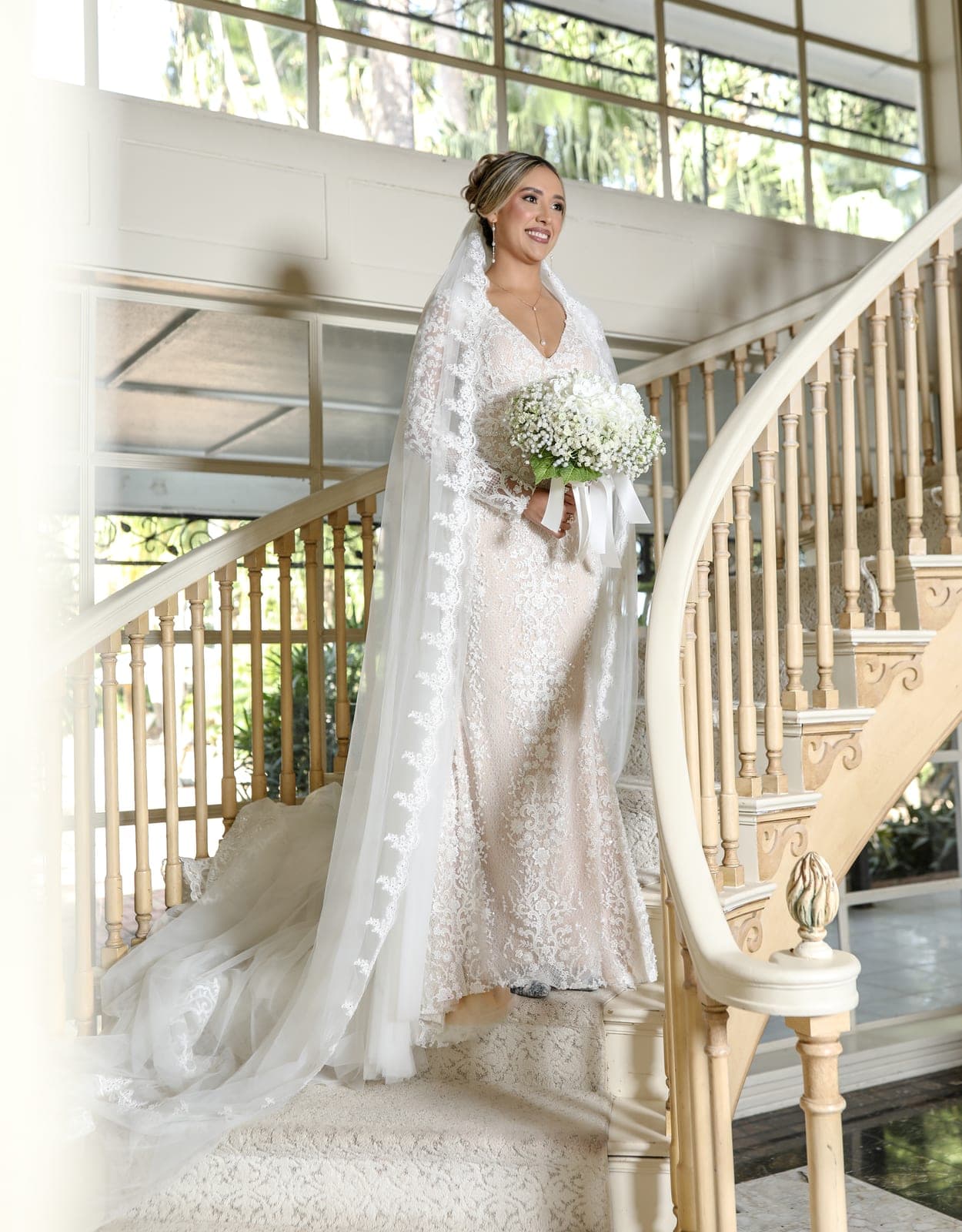 Bride on a grand staircase before her wedding