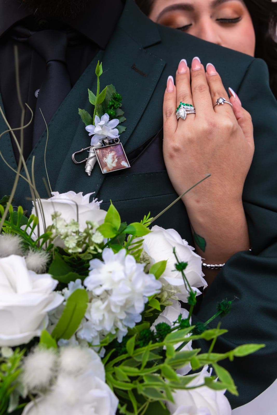 Wedding rings resting on white florals