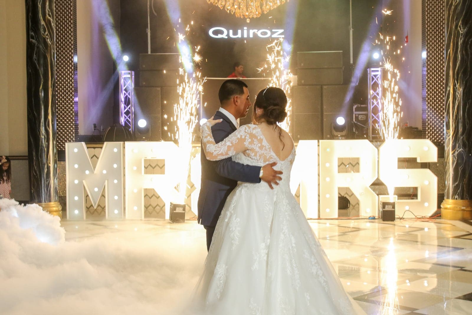 Couple's grand entrance with marquee letters and cold sparks