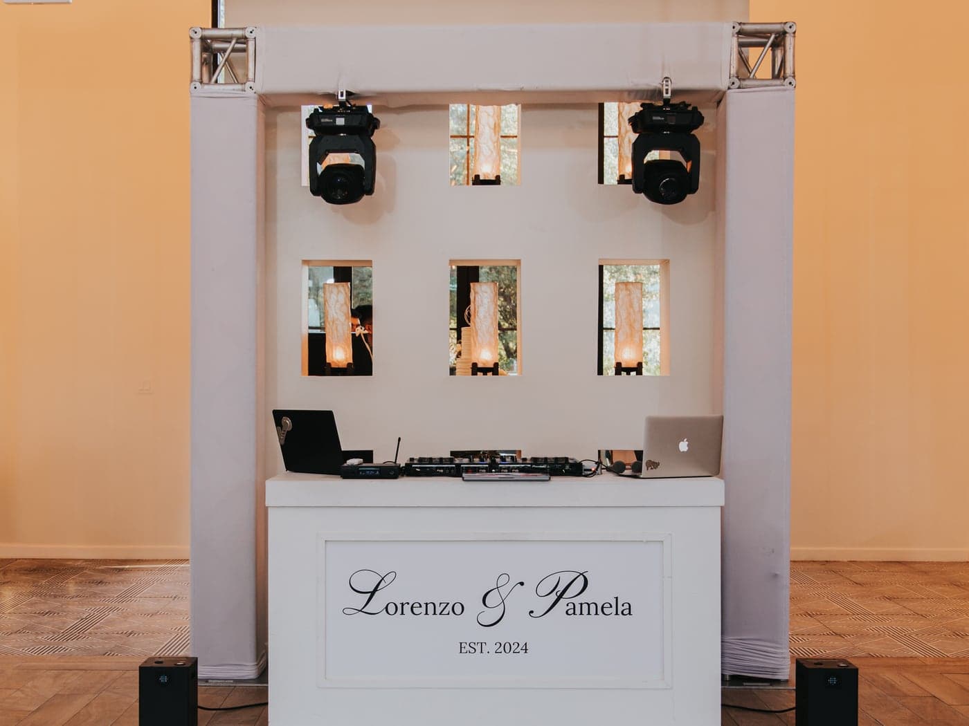 Custom-branded DJ booth with moving-head lighting by AB Event Productions