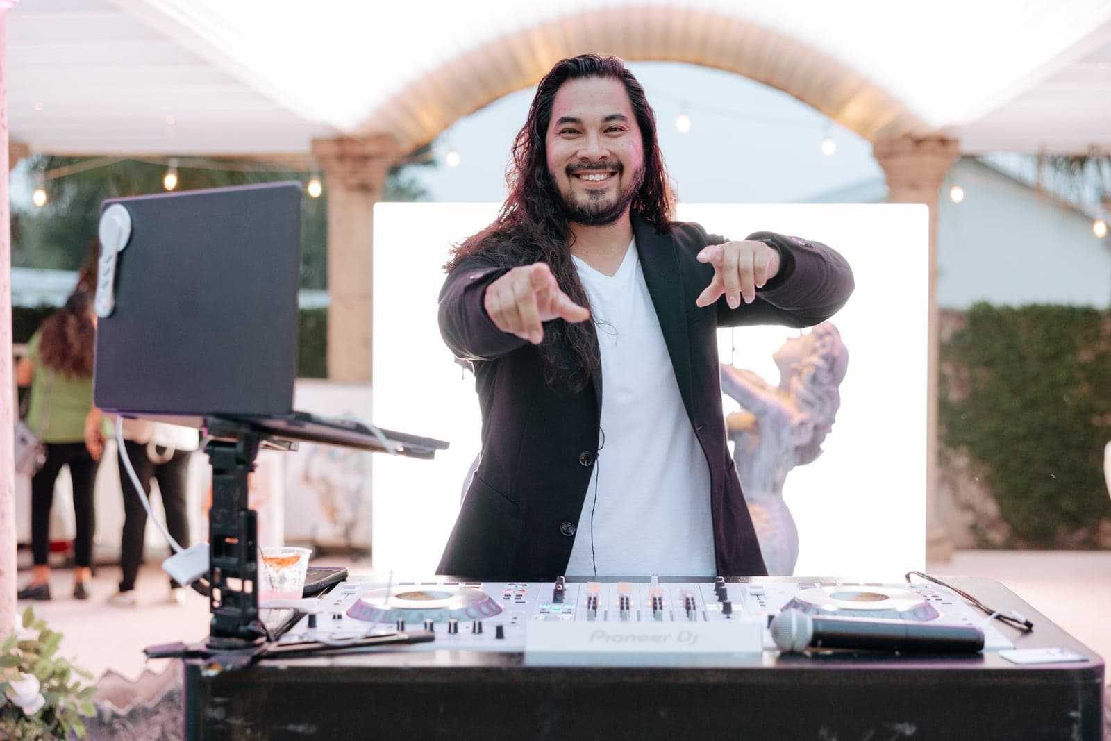 AB Event Productions DJ hyping the crowd from the booth at an outdoor venue